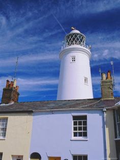 a white lighthouse on top of a blue building