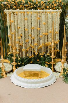 an elaborately decorated stage with flowers and gold decorations for a wedding or special event