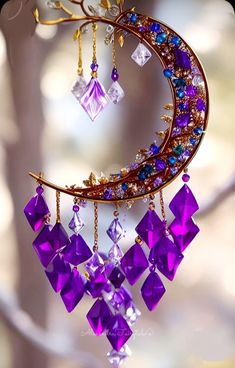 a close up of a wind chime with purple and blue beads hanging from it's side