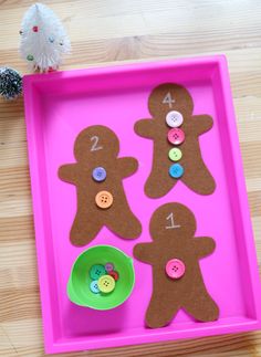 a pink tray with buttons and ginger cutouts on it