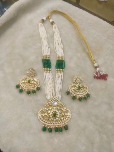 All our pieces are in stock and will be dispatched within 24 to 48 hours of order. Orders received during the weekend will be dispatched on Monday The white and green beads strings on both sides of an elegant Kundan pendant make it a statement wedding necklace. One of our favorite picks for the wedding season 2022❤️ The drop length of the necklace: is approximately 11 inches, and comes with an adjustable string. Length of Earrings: 2 inches White Kundan Jewelry For Jewelry Making, White Jewelry With Stone Work For Gift, Handmade White Temple Jewelry Bridal Necklace, Handmade White Temple Jewelry, Handmade White Bridal Temple Jewelry Necklace, White Traditional Kundan Necklace For Jewelry Making, Handmade Temple Jewelry For Wedding, White Fusion Jewelry With Meenakari, White Pendant Jewelry For Festivals