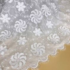 the white lace is on top of a piece of cloth