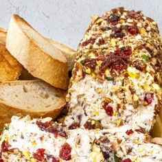 a plate with bread, crackers and cranberry cheese spread on it's side