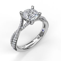 a white gold engagement ring with an oval diamond center and side stones on the band