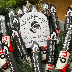 an assortment of toothbrushes with santa claus's hat on them are arranged in a pile