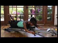 a woman is doing an exercise on a rowing machine