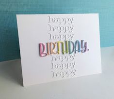 a white card with the words happy birthday written in multicolored letters on it