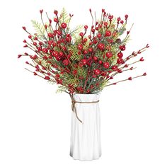 a white vase filled with red berries and greenery