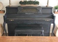 an old piano is sitting in the living room