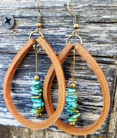 A beautiful drop of natural Turquoise dangles inside these large, handmade Latigo leather earrings. Turquoise stones are matched by hand to compliment each other in size, shape, and color, making this a striking and unique pair. (These stones are genuine Turquoise, not dyed magnesite or howlite.) Personalize your earrings with the following leather color options: black, mahogany, tan, beige, white, and silver. Earwires, jump rings, and posts are nickel-free and come in either antique brass or si Leather And Turquoise Earrings, Leather Strip Earrings, Leather Beaded Earrings, Leather Earrings Ideas, Leather Jewelry Diy, Diy Leather Earrings, Leather Supplies, Turquoise Drop Earrings