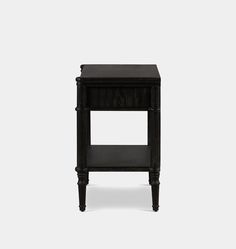 an end table with one drawer on the top and two drawers on the bottom, all in black