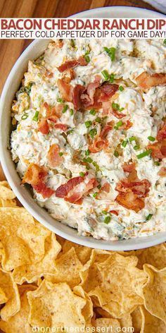 bacon and ranch dip in a white bowl surrounded by tortilla chips