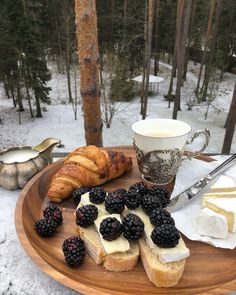 bread, butter and berries on a wooden plate