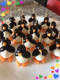 there are many penguin shaped treats on the plate