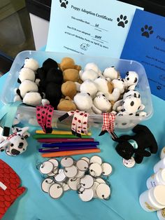 there are many stuffed animals on display at the table with their name tags and pencils