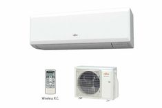 a white air conditioner sitting next to a remote control and wall mounted heat pump