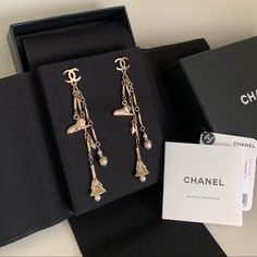 Brand New. Never Been Worn. Chanel Gold Long Dangly Earrings. Cc Logos And Charms And Pearls In Soft Gold. Special, Fancy, And Lovely. 3.5” Long. Made In France. Includes Box, Tags And Velvet Case. Perfect Condition. Designer Dangle Earrings For Evening, Designer Dangle Earrings For Parties, Chanel Stud Earrings, Vintage Chanel Earrings, Long Pearl Earrings, Jewelry Chanel, Long Gold Earrings, Costume Earrings, Clover Earrings