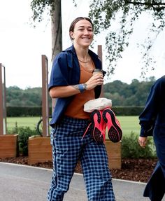 a woman is walking down the street with her shoes