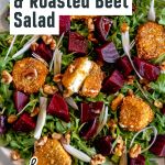 there is a salad with beets and nuts on it