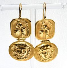 "The gold looks like 18k gold quality. The Medusa image is beautiful and powerful. The earrings are just over 2\" long and over .75\" wide. The latch on the ear piece is a great security factor. This is a stunning pair of earrings." Italian Gold Earrings, Ornate Gold-tone Metal Jewelry, Medusa Images, Yellow Gold Medallion Brass Earrings, Roman Coin Earrings, Ornate Gold-colored Sterling Silver Earrings, Clear Bracelet, Greek Mythology Jewelry, Mythology Jewelry