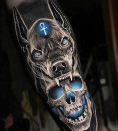 a man's arm with a dog and skull tattoo on it