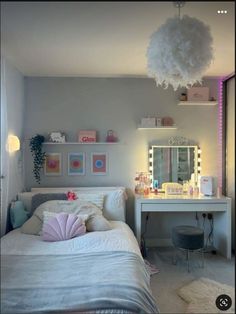 a bedroom with a bed, desk and mirror