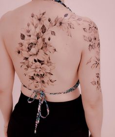 the back of a woman's body with flowers on it