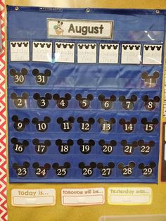 a mickey mouse calendar is displayed on the wall