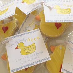 some yellow rubber ducks are wrapped in plastic and have tags on them to say i'm lucky duck