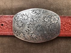 "90s southwestern embossed leather belt with pewter tone engraved belt buckle.  c. 1994. Size XL. Fits a waist range of approx 40\"-44\" on 5 notches.  Recommended for 40\"-42\". About 1.5\" wide Buckle 2 3/8\"x 3.5\"" Western Style Engraved Adjustable Belts, Western Engraved Adjustable Belt, Western Style Adjustable Engraved Belts, Western Adjustable Engraved Belts, Vintage Silver Hand Tooled Belt Buckles, Vintage Silver Belts For Rodeo, Engraved Adjustable Western Belt Buckles, Silver Hand Tooled Adjustable Belt Buckles, Adjustable Silver Hand-tooled Belt Buckles