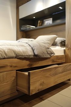 a bed with two drawers underneath it