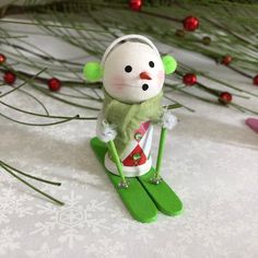 a snow skier ornament sitting on top of a table next to christmas decorations