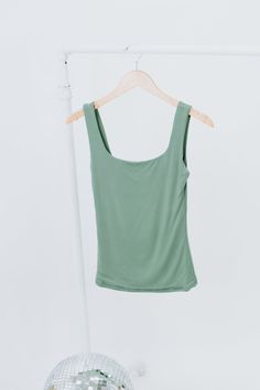 The Double Layered Reg Length Tank is a must-have for a casual summer wardrobe, offering the best basics with its double-layered design that adds a touch of uniqueness to a cute and solid shirt. This stylish and lightweight tank effortlessly embodies a summer aesthetic. Double Layered Tee Fixed straps Premium ribbed knit fabrication Fit: Fitted; Generous stretch Fabric: 92% Nylon 8% Spandex Model Specs: Emily + Karli are wearing a size small in the photo.How will this item fit you? Check out our Versatile Solid Color Tops For Loungewear, Stretch Solid Color Summer Tops, Basic Green Seamless Tops, Soft Stretch Scoop Neck Summer Top, Soft Stretch Scoop Neck Top For Summer, Soft Stretch Summer Tops, Stretch Solid Tops For Day Out, Solid Stretch Tops For A Day Out, Versatile Green Seamless Tops