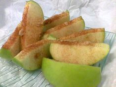 an apple sliced in half on a glass plate