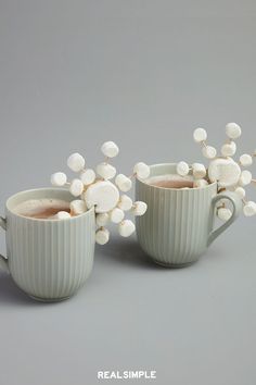 two mugs filled with hot chocolate and marshmallows