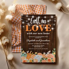 the fall in love wedding card is displayed next to some flowers and cotton floss