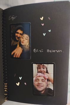 an open photo album with two pictures and hearts on it, the cover is black