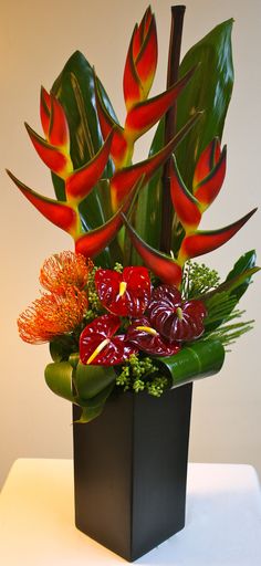 an arrangement of flowers in a black vase