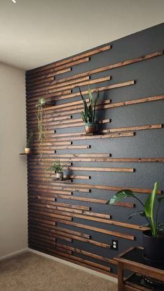 a living room with some plants on the wall and a video screen showing how to use it