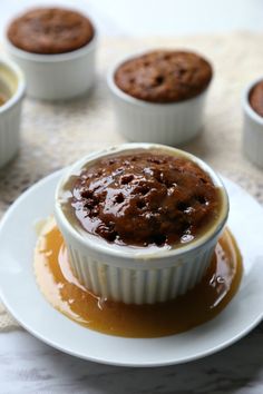 there is a chocolate cupcake on the plate with caramel sauce