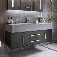 a modern bathroom with marble counter tops and gold handles on the faucet sink