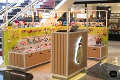 the inside of a store with many items on display and stairs leading up to it