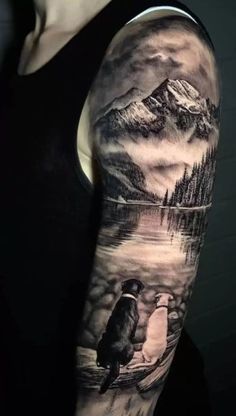 a man with a tattoo on his arm and shoulder is standing in front of a mountain lake