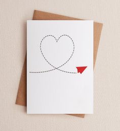 a card with an airplane flying in the shape of a heart