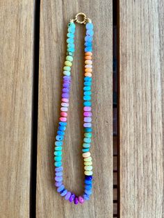 Opal necklace in rainbow colors strung and knotted by hand. Spring clasp in 14k gold. Length 49 cm