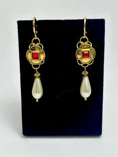 Queen's Earrings fit for a Tudor Court!  These earrings would make a lovely matching set with either our Jane Seymour necklace set, the Catherine Parr or the Elizabeth 1st necklace set in our shop. The earrings are made with a gold plated lever back hoop for pierced ears.  There is a faux pearl and Tudor replica ouches in gold plate with red crystal square. I can also make these earrings with a black crystal. Each earring measures approximately 5 cm in drop length. The earring clips are Zinc Bas Antique Earrings With Historical Design For Ceremonial Occasions, Formal Drop Earrings With Historical Design, Ornate Historical Design Earrings, Baroque Jewelry With Historical Design For Formal Occasions, Baroque Historical Jewelry For Formal Occasions, Baroque Historical Design Jewelry For Formal Occasions, Antique Drop Earrings With Historical Design, Traditional Formal Jewelry With Historical Design, Antique Wedding Earrings With Historical Design