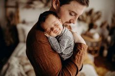 a man holding a baby in his arms