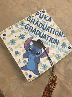 a graduation cap with stitching on it and a tassel hanging from the side