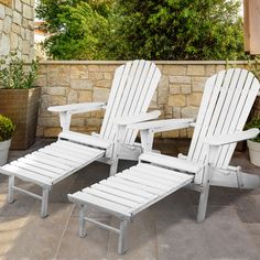 two white lawn chairs sitting next to each other