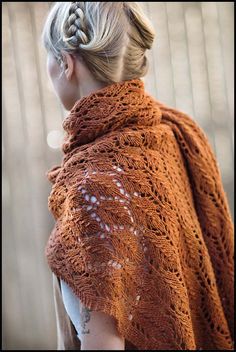 a woman wearing an orange knitted shawl